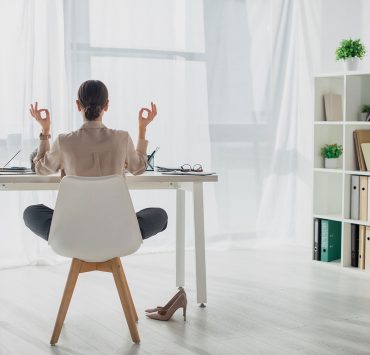 12 Yoga Poses You Can Do at Your Work Desk to Relieve Stress