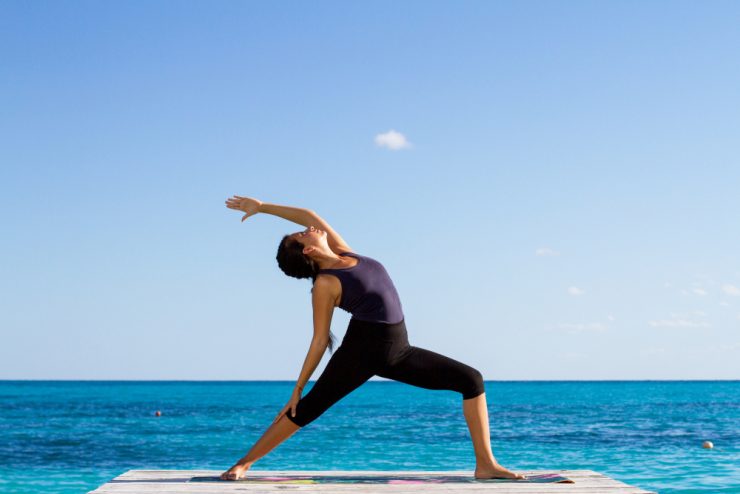 Woman practicing Yoga Reverse Warrior pose