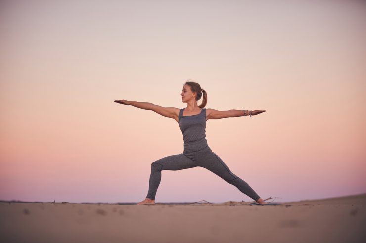 Woman practicing Yoga Reverse Warrior pose